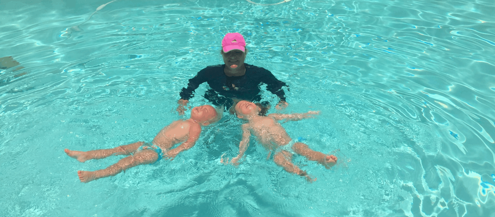 two children learning to swim