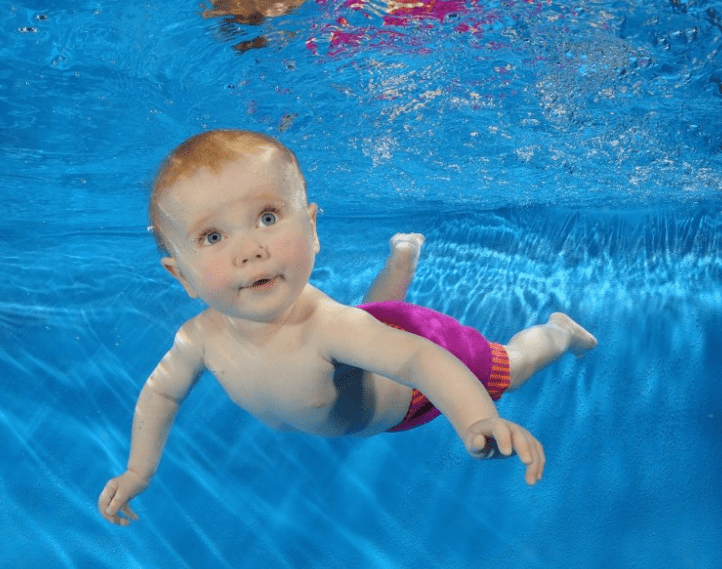 boy learning to swim