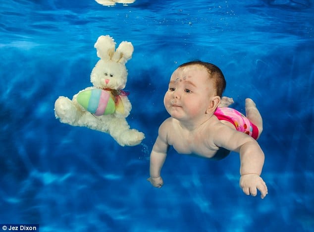 baby learning to swin underwater