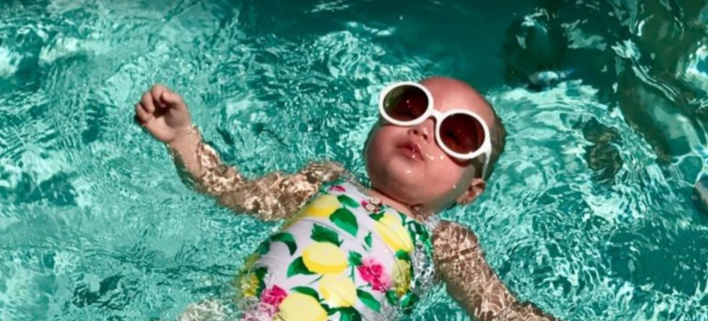 infant girl learning to swim